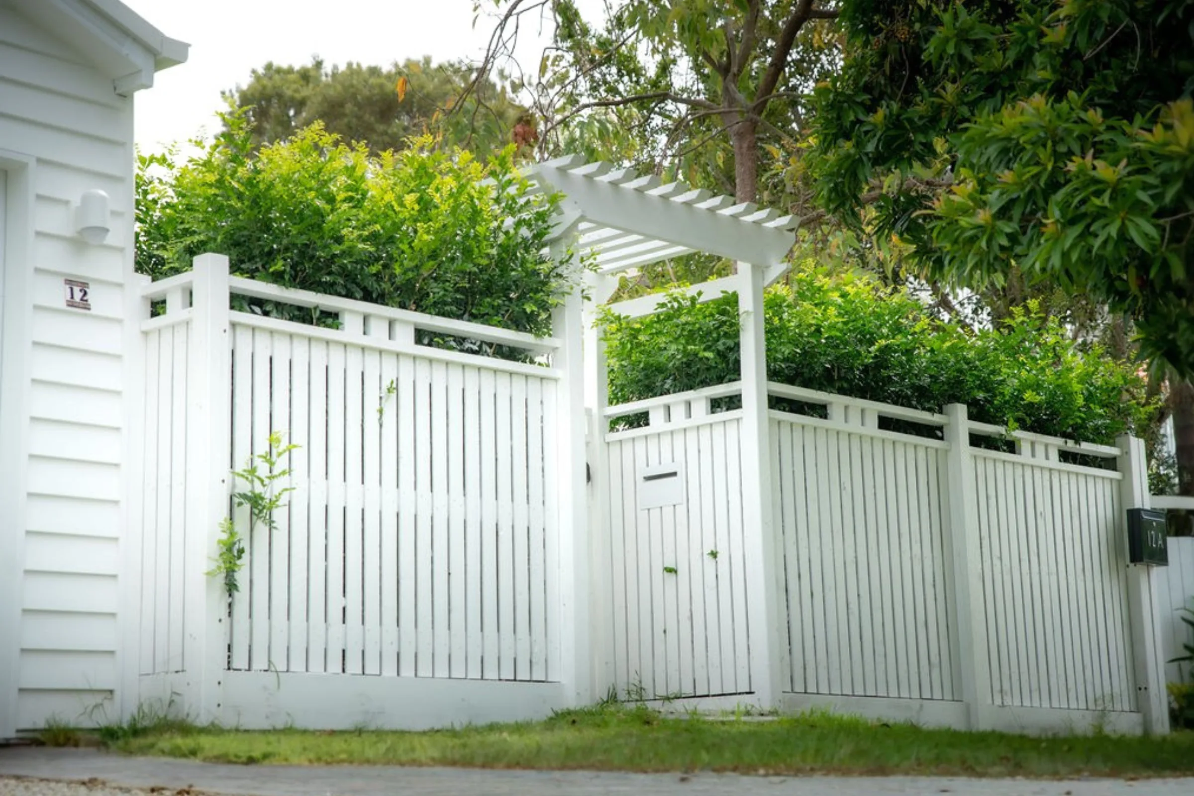 White pergola entry and slatted timber fence on a Brisbane character cottage