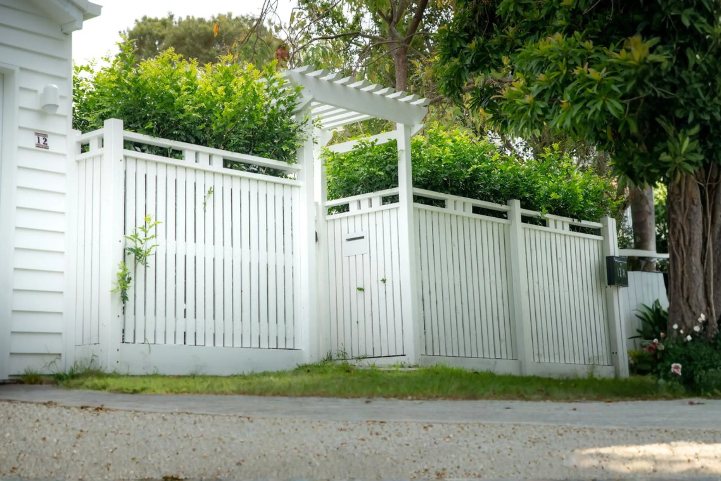 White pergola entry and slatted timber fence on a Brisbane character cottage
