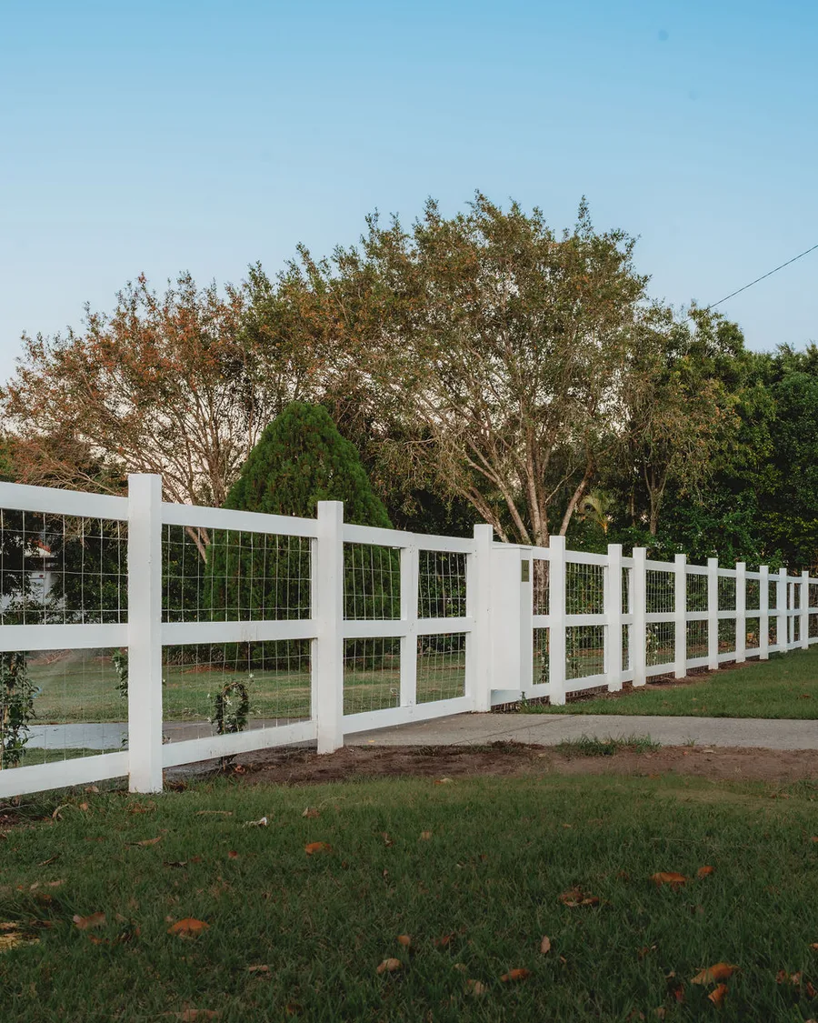Rural-style post-and-rail with mesh infill — semi-rural acreage property.